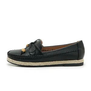 Detailed side view of black casual loafers with bow accent and rope-wrapped sole