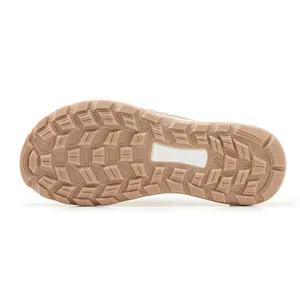 Close-up of the non-slip tan rubber outsole with tread pattern for women's flat sandals