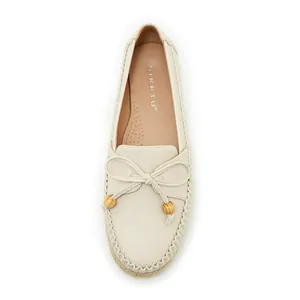 Detailed top view of comfortable cream women's loafers featuring bow and wooden bead accents