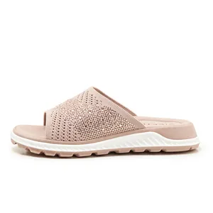 Close-up of pink fly-knit slide sandal with rhinestone detailing and comfortable flat sole
