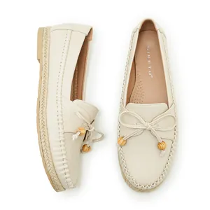 Top view of cream casual loafers with bow detail and soft textured leather insole