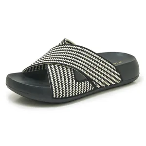 Detailed view of comfortable platform slide sandal with woven black and white cross straps