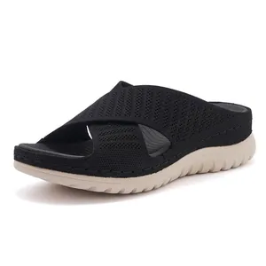 Women's black fly-knit athletic sandals with cross straps and thick platform soles