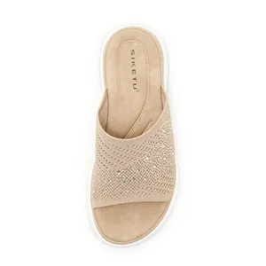 Top-down detail of beige fly-knit flat slide sandal with sparkling rhinestone patterns