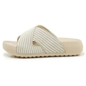 Detail showing the knitted cross-strap texture and thick sole of these beige summer slides.