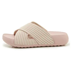Side profile of women's pink platform slides with breathable criss-cross knit straps.