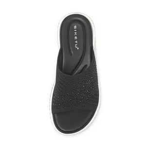 Top-down view of black fly-knit slide sandal featuring sparkling rhinestone details
