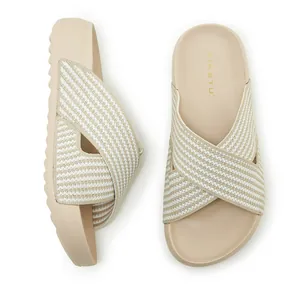Detailed view of beige platform slide sandals with striped criss-cross fabric straps