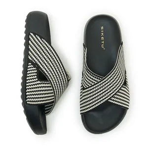 Women's platform slides featuring a breathable black and white woven cross-strap