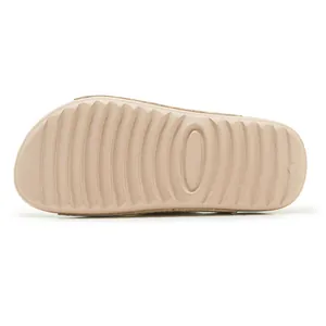 Close-up detail view showing the anti-slip ripple texture on the beige platform slide outsole
