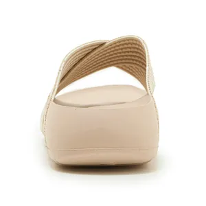 Rear view of beige platform slide sandal with thick cushioned soles and crossover fabric straps