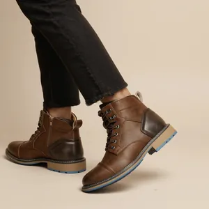 Detail view showing vintage brown men's Martin boots with side zipper and blue sole