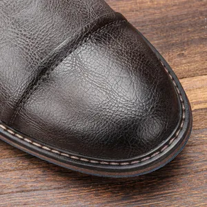 Macro view of vintage distressed brown leather boot toe with stitching details