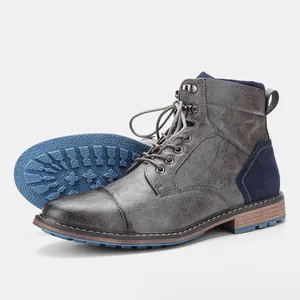 Close-up of distressed grey leather Martin boots with non-slip blue rubber sole