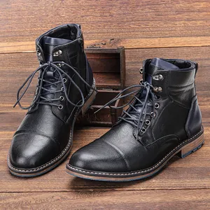 Detail view of black vintage men's Martin boots with blue accents on wood background