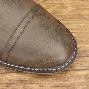 Detailed macro view showing the vintage rubbed leather and stitching on a men's Martin boot toe