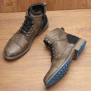 Side and sole view of vintage brown men's work boots with blue lugged treads