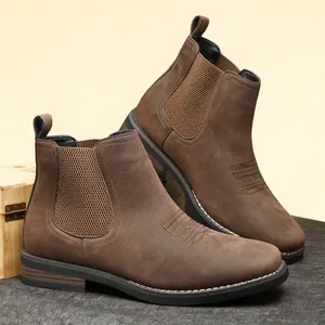 Side view showing the suede texture and stitched details of the brown Chelsea boots.