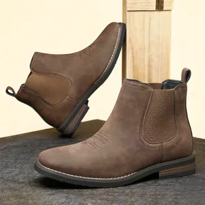 Detailed view of brown suede-textured men's Chelsea boots with elastic side panels.