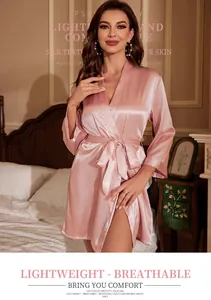 Close-up detail of sexy women's pink satin belted bathrobe with breathable silk texture