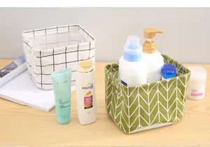 Detailed view of green chevron and white grid fabric storage baskets holding toiletries.