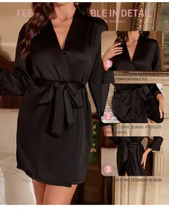 Close-up of black satin robe features including low V-neck and fine sewing details