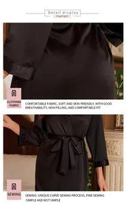 Close-up detail of the smooth black satin fabric and tied belt on a luxury ladies bathrobe