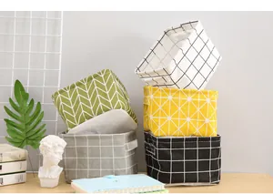 Set of diverse patterned cotton linen desktop storage baskets shown on a styled desk