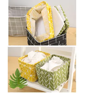 Detail view of printed cotton linen storage baskets in folded and standing positions