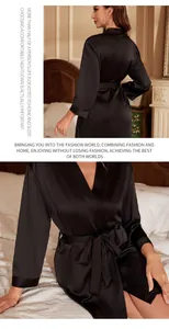 Close-up detail of black silk-like bathrobe with elegant tie-waist and smooth texture