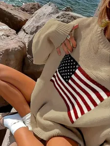 Detail shot of a beige knit sweater featuring a vintage American flag pattern