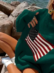 Close-up detail of a dark green oversized knit sweater featuring a vintage American flag pattern