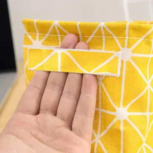 Yellow geometric pattern cotton linen storage basket close-up showing reinforced handle detail