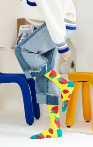 Gros plan sur des chaussettes en coton jaune vif avec motifs de fraises rouges