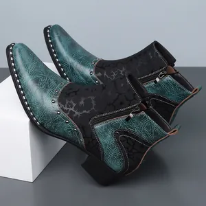Detailed view of teal and black Chelsea boots with marble texture and stud accents