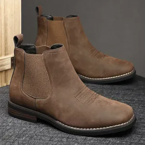 Macro view showing the textured brown leather and elastic side panel of these men's boots