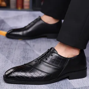 Classic men's black Oxford dress shoes featuring embossed crocodile leather textures