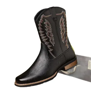 Detail view of retro white and brown embroidered stitching on black western cowboy boots