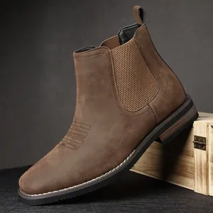Detail view of brown suede Chelsea boot showing side elastic and stitching
