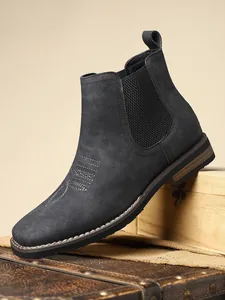 Close-up of stylish grey suede Chelsea boots for men with elastic side panels