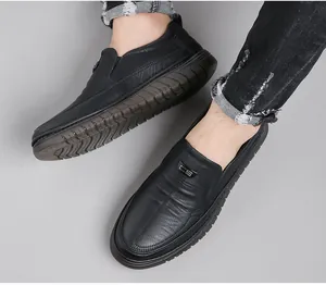 Detail view of men's black slip-on leather shoes with anti-slip sole and CS logo