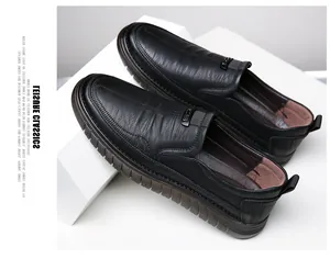 Detail showing the textured black leather finish of these stylish slip-on men's shoes.
