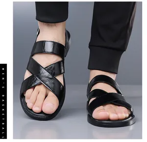 Close-up of black leather cross-strap sandals for men, stylish summer beach footwear