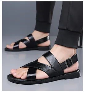 Close-up detail of men's black leather cross-strap sandals with soft sole and buckle strap