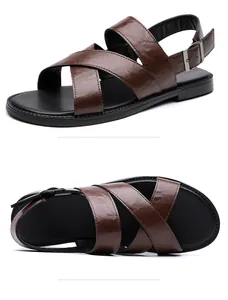 Detail view of brown leather men's sandals with cross straps and adjustable buckle closure
