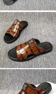 Detailed view of men's brown crocodile texture leather sandals with non-slip sole