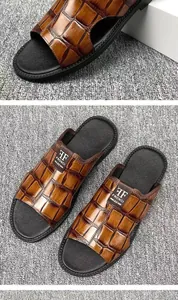 Close-up of men's brown crocodile embossed leather slippers with brand logo detail