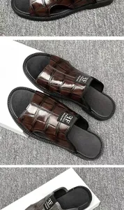 Macro view showing the glossy crocodile pattern texture on brown leather sandals
