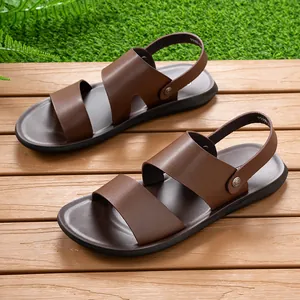 Detailed view of brown men's breathable dual-use beach sandals on outdoor wooden deck