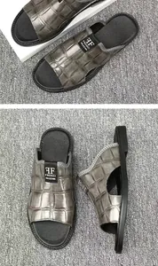 Close-up of men's casual sandals featuring a grey crocodile skin texture and side cutout.